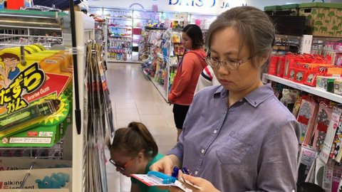 VUNG TAU, VIETNAM - NOVEMBER 7, 2017: People watch and choose goods at a Lottemart supermarket department with japanese goods at 2 dollars each.