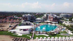 Amazing top view on tropical luxury hotel With swimming pool at near ocean. Video. Top view of the luxury hotel near the sea