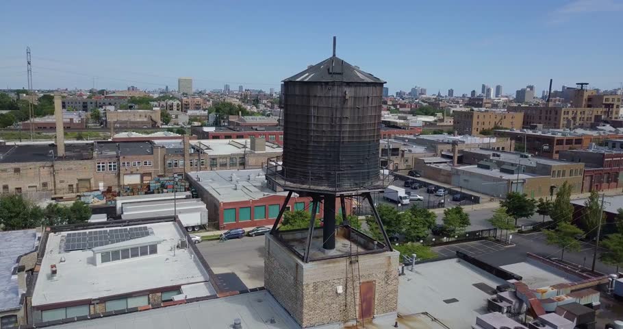 An aerial drone shot, orbiting clockwise around a water tower in Chicago.