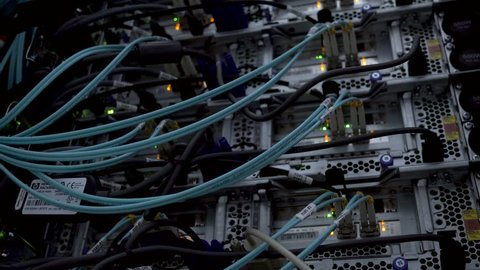 RUSSIA, MOSCOW - August 06, 2018: Fiber Optical connector interface. Fibre Channel swich. Severs computer in a rack at the large data center.  Blinking lights. Close-up. Editorial