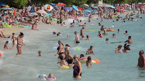 Tucepi, Croatia, 19th august 2018, People sunbathing and swimming. Tourists on the beach enjoying and having fun 
