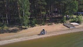 Motorcyclist riding alone in woods. Clip. Aerial view. Motorcycle racing