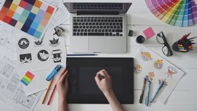 Creative designer using graphics tablet while working at her table - Powered by Shutterstock - Get 15% off with code: PIKWIZARD15