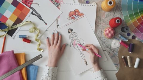 Fashion designer drawing clothes sketch