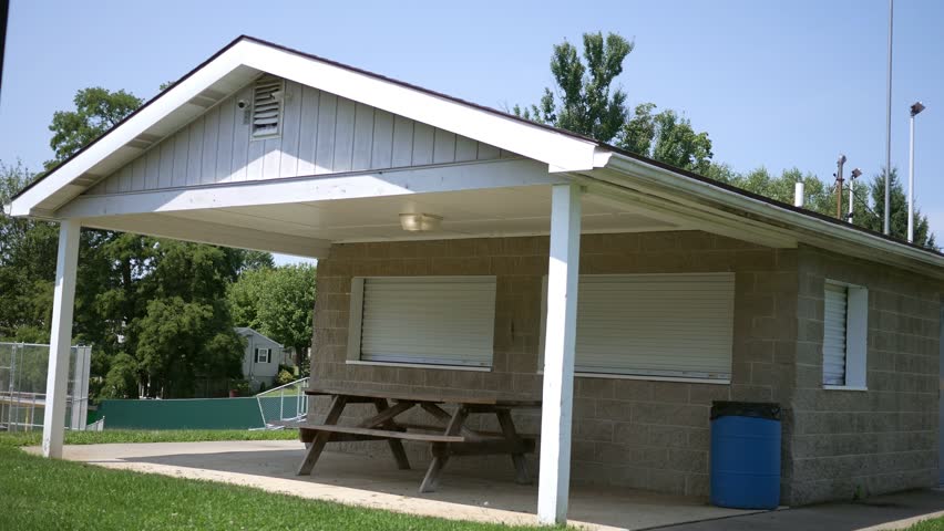 An establishing shot of a small town concession stand temporarily closed near baseball field