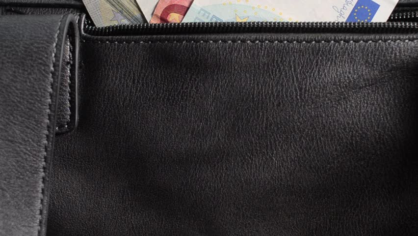 Glamour handbag with money. Woman hand takes out twenty euros out of her bag pocket.