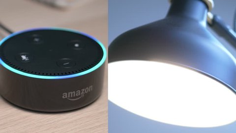 MONTREAL, CANADA - August 2018 : Smart home voice activated assistant turning the light ON and then OFF. Amazon Echo Alexa Dot