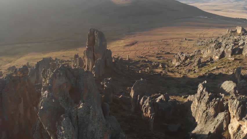 Back away aerial view of a Hatun Cocha stone wood in the andes of Ancash, Peru at the sunset.