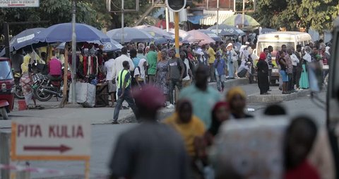 Dar Es Salaam / Tanzania - July 17 2018: Streets of Dar Es Salaam, crowd of people and busy traffic, A Major City And Commercial Port On Tanzania Indian Ocean.Population explosion, population growth, 
