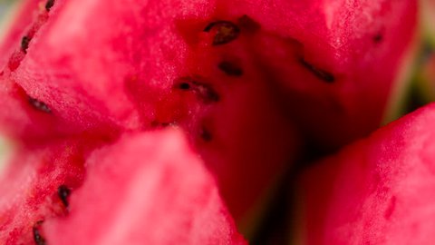 Appetizing Juicy Pulp of Watermelon. Triangular pieces of watermelon are on a rotating fruit plate. Camera looks sideways down