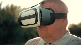 Elderly Man Using Virtual Reality Headset Outdoor.