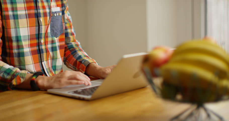 4K Geeky guy with glasses and afro hair listening to music through headphones. Slow motion.
