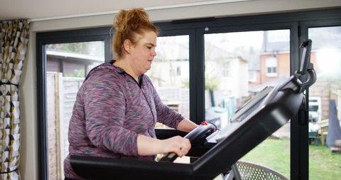 4K Unhappy obese woman trying to lose weight exercising & frowning at camera. Slow motion.
