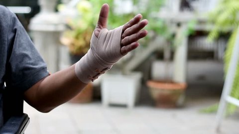Showing injury hand with elastic bandage 