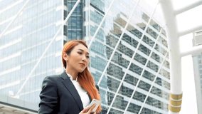 Young Asian Business woman taking selfie photo using smart phone for social media. Happy businesswoman in suit in urban city