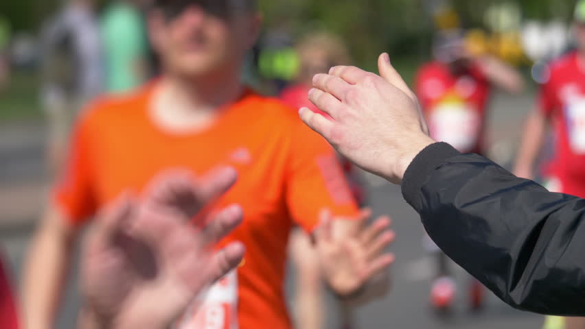 Man giving runners high five in 4k slow motion 60fps

