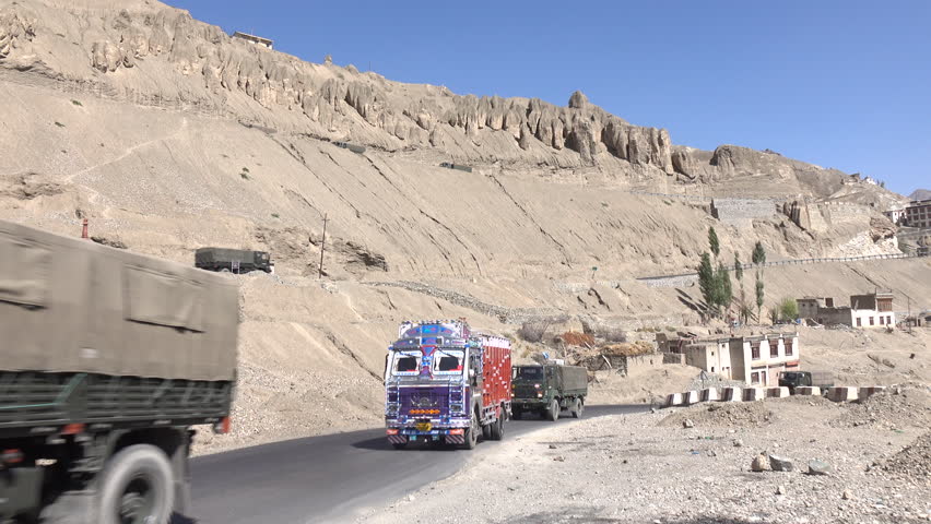 Military trucks drive on the road at Lamayuru in Leh Ladakh, Jammu and Kashmir, India