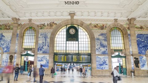 Porto, Portugal - January 16, 2018: Time lapse of the people in the vestibule of Sao Bento Railway Station. It is decorated with approximately 20,000 azulejo tiles, dating from 1905-1916