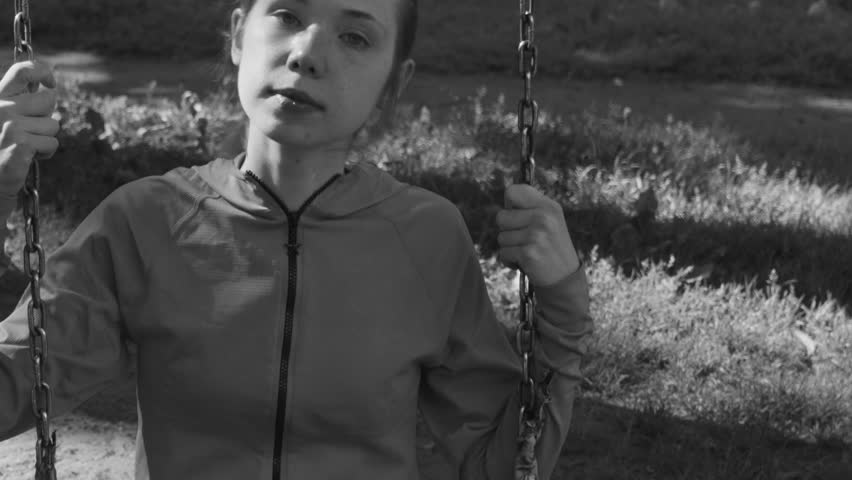 girl is riding on a swing