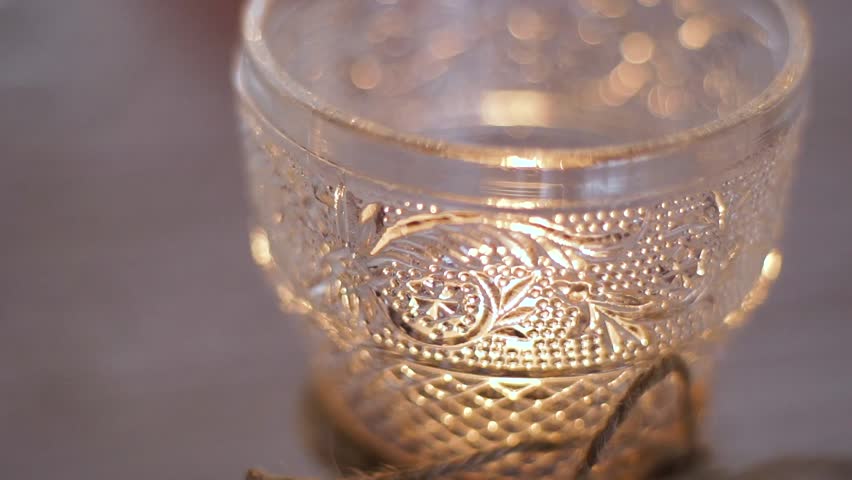 Closeup of burning candle in a pretty glass. | Shutterstock HD Video #1015289704