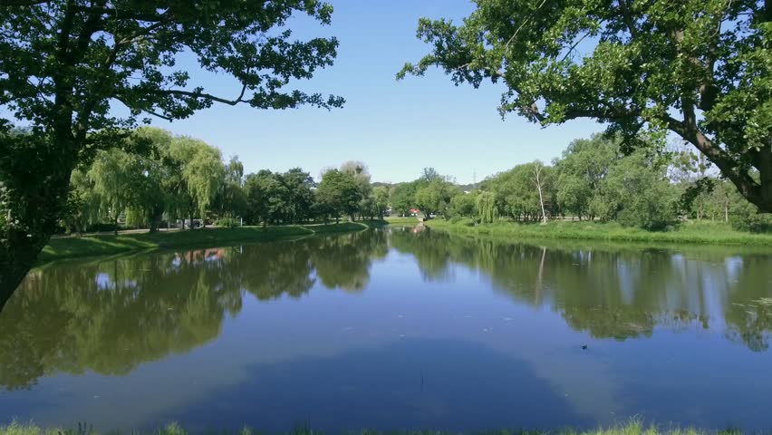 4K. AERIAL VIEW. The lake in the park. city Gdansk Poland. Sunny morning, beautiful scenery with a lake in the park.