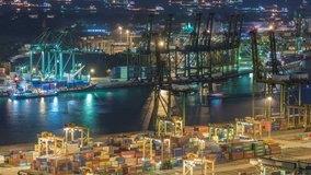 Commercial port of Singapore night timelapse. Bird eye panoramic aerial view of busiest Asian cargo port with hundreds of ships loading export and import goods and thousands of containers in harbor - Powered by Shutterstock - Get 15% off with code: PIKWIZARD15