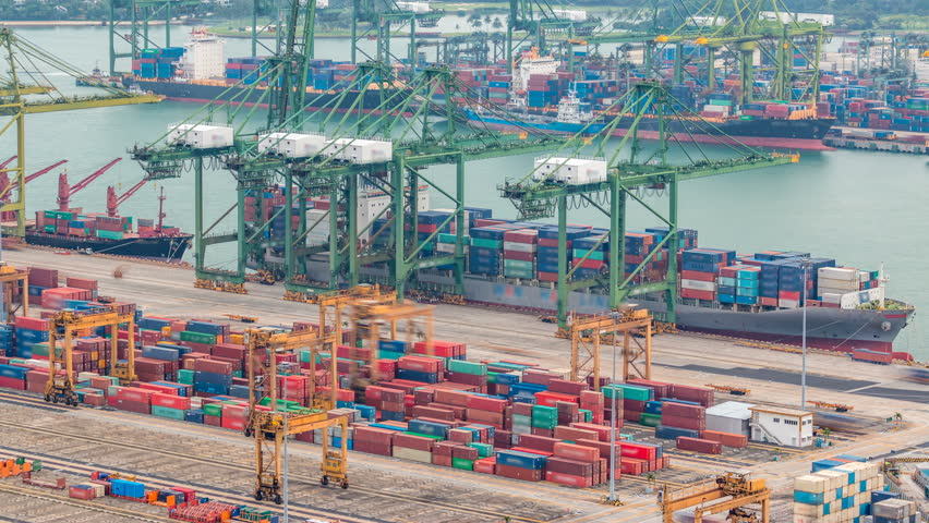 Commercial port of Singapore timelapse. Bird eye panoramic aerial view of busiest Asian cargo port with hundreds of ships loading export and import goods and thousands of containers in harbor Royalty-Free Stock Footage #1015296994