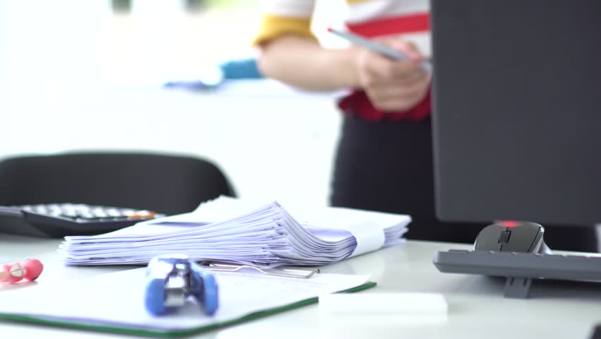Woman writing business documents manual handling.working with documents in office. | Shutterstock HD Video #1015301020