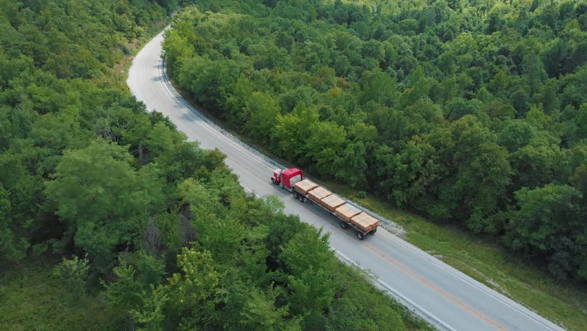 Semi Transport Truck Driving with Lumber Wood in Country.
