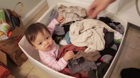 Funny Baby Hiding in Laundry Basket