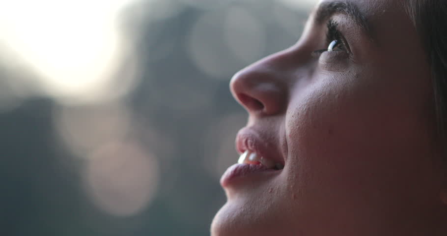 Young woman face opening eyes in meditation and contemplation loooking up at the sky with hope and faith Royalty-Free Stock Footage #1015309984