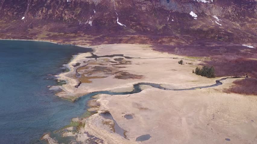 Alaskan fjord wetlands area,across a backwater body, fall has set in and winter is about to start. (Valdez ,Alaska) (Drone Shot)
