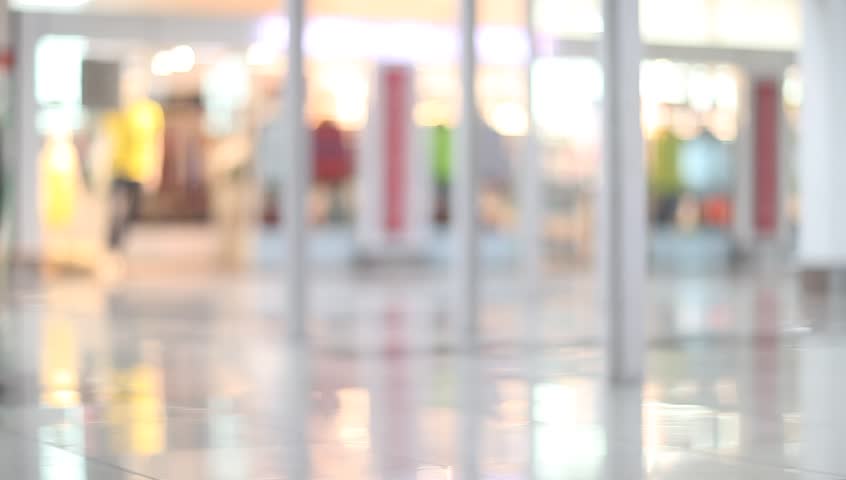 Passengers with luggage walking in Airport.  Travel people out of focus and blurry in background.