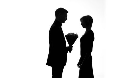 Boyfriend giving flowers girlfriend, happy couple shadow kissing, romantic date
