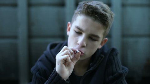 Boy smoking cigarette, influence of street and bad company, childrens protest