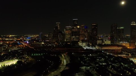 Aerial lateral establishing shot Houston Texas at night