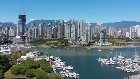 Vancouver, British Columbia, Canada, aerial view of False Creek showing Granville Island, Spruce Harbour Marina and Vancouver skyline during daytime.