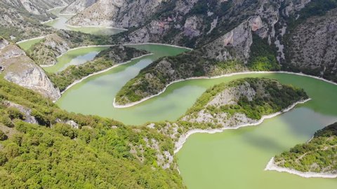 Aerial view meanders of river Uvac. Flying over the beautiful river and mountain, sunny day. Aerial drone shot, landscape panorama. River and lake Uvac in Serbia