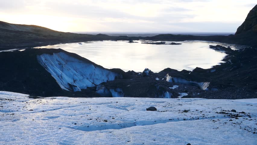 Top view of a frozen lake shaped by melting of glacier ice due to global warming 