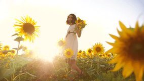 Cute child girl in yellow garden of sunflowers sunlight in summer. beautiful sunset lifestyle little girl in sunflowers. slow motion video. girl teenager and sunflowers field concept agriculture