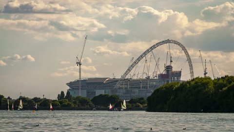 London, UK - August 8th 2018: Time lapse of Boats racing in London, England with the Wembley Stadium in the background on a cloudy summer day