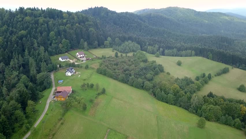 Beautiful aerial shot of green hills and valleys. Nature of Bieszczady Mountains seen from above.