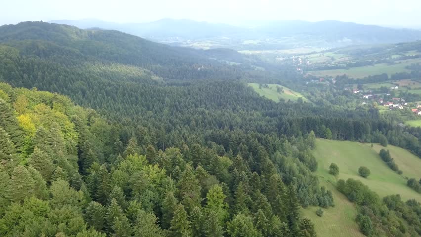 Beautiful aerial shot of green hills and valleys. Nature of Bieszczady Mountains seen from above.
