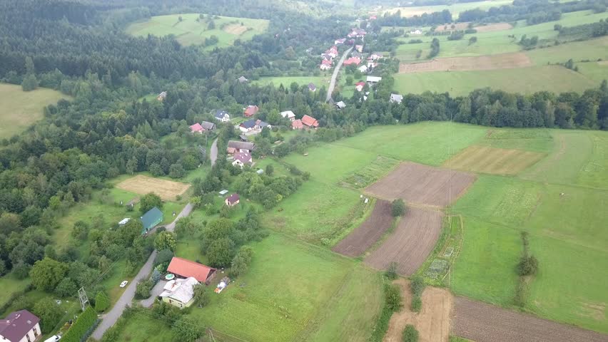Beautiful aerial shot of green hills and valleys. Nature of Bieszczady Mountains seen from above.