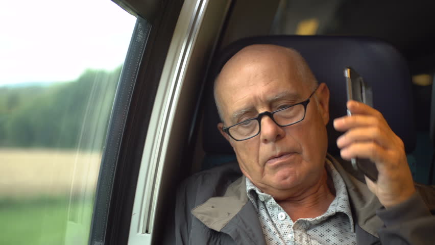 Boss disagreeing angrily while talking on mobile phone in train - Model Released Royalty-Free Stock Footage #1015383358