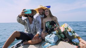 Modern multi ethnic friends taking photo or video with smartphone on long tail boat tour in Asia Thailand. Asian summer holiday travel vacation adventure. Slow motion travel hand held in Asia. 