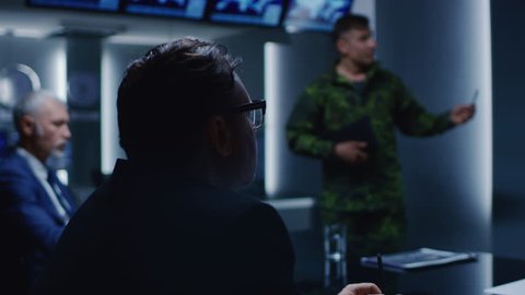 High-Ranking Military Man holds a Briefing to a Team of Government Agents and Politicians, Shows Satellite Surveillance Footage. Joint Operation of Federal Special Agents and Army Personnel. 4K UHD.