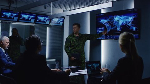 High-Ranking Military Man holds a Briefing to a Team of Government Agents and Politicians, Shows Satellite Surveillance Footage. Shot on RED EPIC-W 8K Helium Cinema Camera.