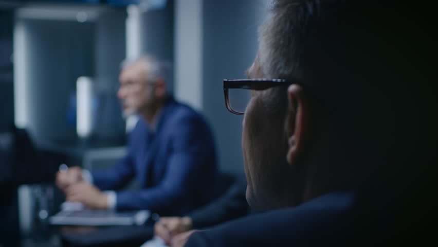 Portrait of the Senior Member of the Board Of the Directors Listening to His Business Partners on a Meeting. Shot on RED EPIC-W 8K Helium Cinema Camera. Royalty-Free Stock Footage #1015398736