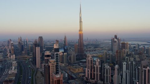 Aerial sunset city view Sheikh Zayed Road Downtown Business Bay commercial area modern vehicle transport highway United Arab Emirates Middle East Dubai RED WEAPON